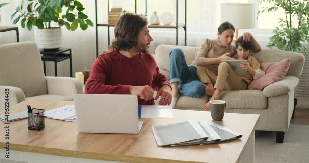 Woman talking with husband working from home while son is using digital tablet Woman talking with husband working from home while son is using digital tablet