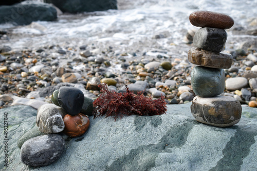 Pyramide de galets et algue rouge, océan, vagues, rocher, écume photo