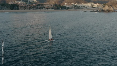 Touristic boat near coastline on sunset