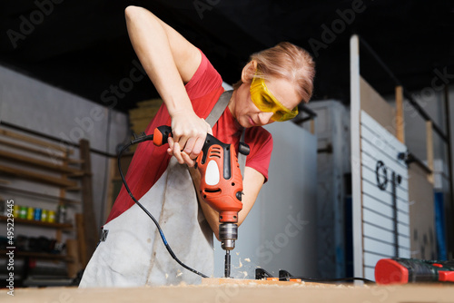 workbench in industry. woman works in carpentry workshop