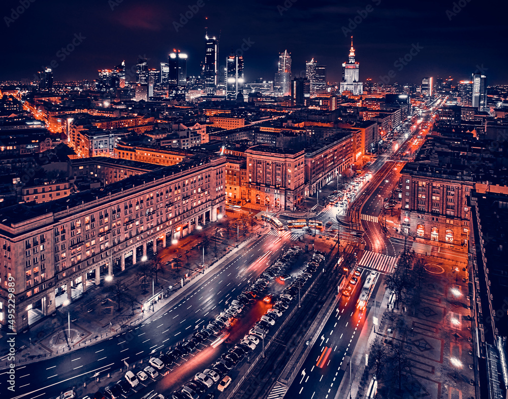 Obraz premium Constitution Square (PL: Plac Konstytucji) - a view of the center of night Warsaw with skyscrapers in the background - the lights of the big city by night, Poland, EU