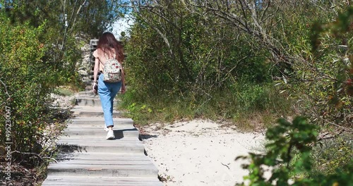 Curonian spit, beautiful vibrant view of Kurshskaya Kosa National Park, Curonian Lagoon and the Baltic Sea, Kaliningrad Oblast, Russia and Klaipeda County, Lithuania, summer day, with a female tourist photo