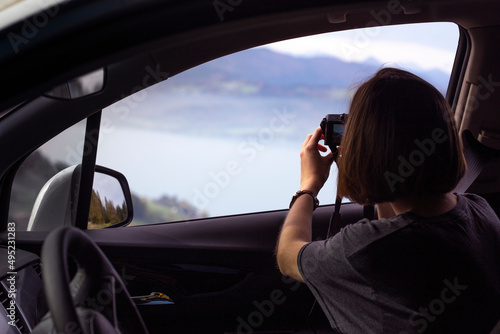 girl takes a beautiful landscape on a camera