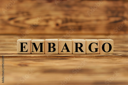 Embargo. Word on wooden blocks. Isolated on a gray background. Business. Politics. Economy. Conflict between Ukraine and Russia. Crisis, poverty, starvation. Conceptual.