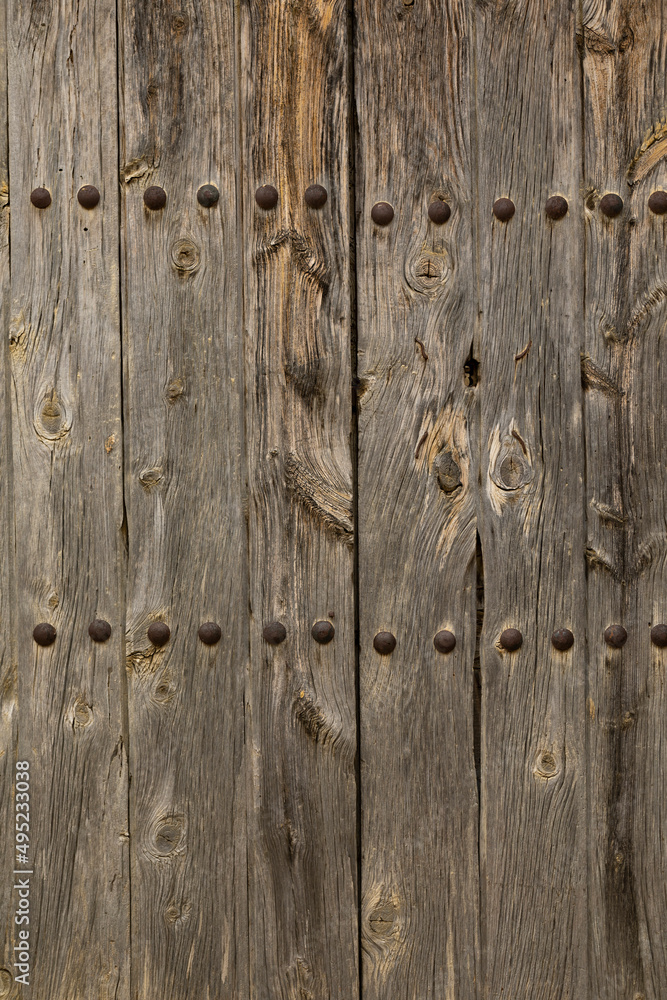Fototapeta premium Background texture of an old worn wooden door in the village of Luna, in the region of Cinco Villas, province of Zaragoza, Aragon, Spain