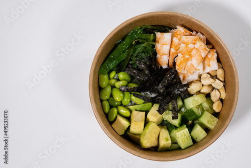 fresh food with shrimps, green beans, rice, nuts and seaweed