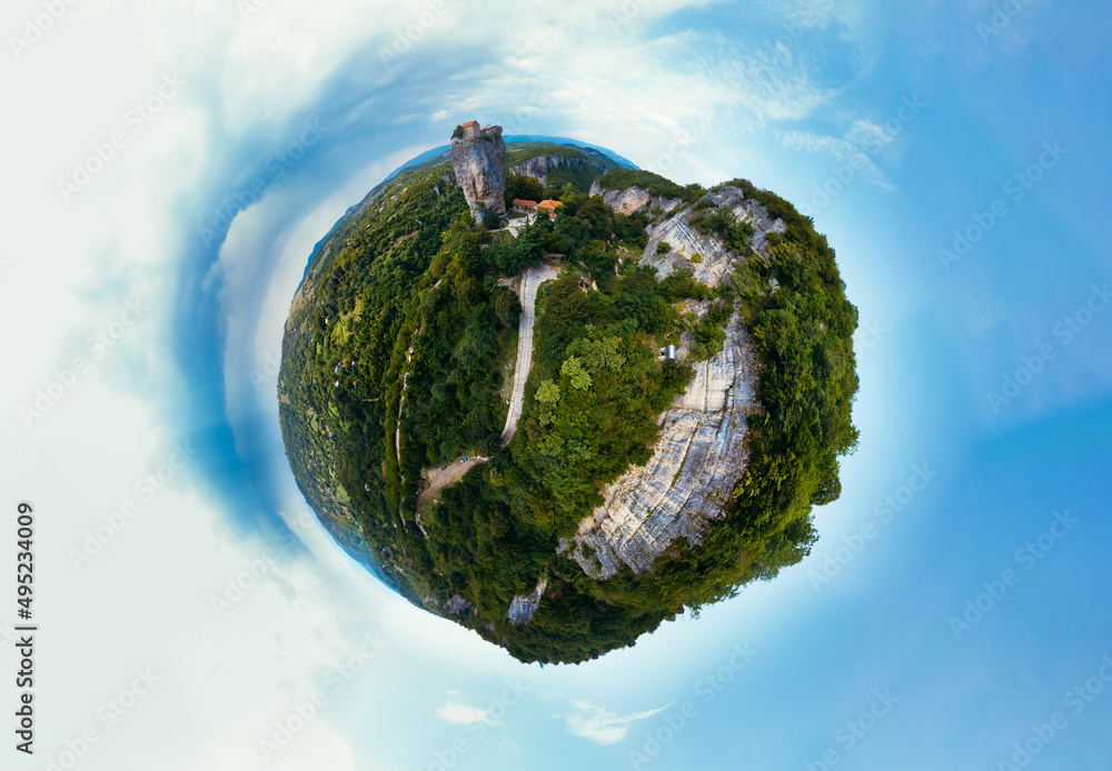 Fototapeta premium Little planet view. Katskhi pillar. Georgian landmarks. Man's monastery Katskhi. The orthodox church and the abbot cell on a rocky cliff. Imereti, Georgia. Summer day. Travel and tourism