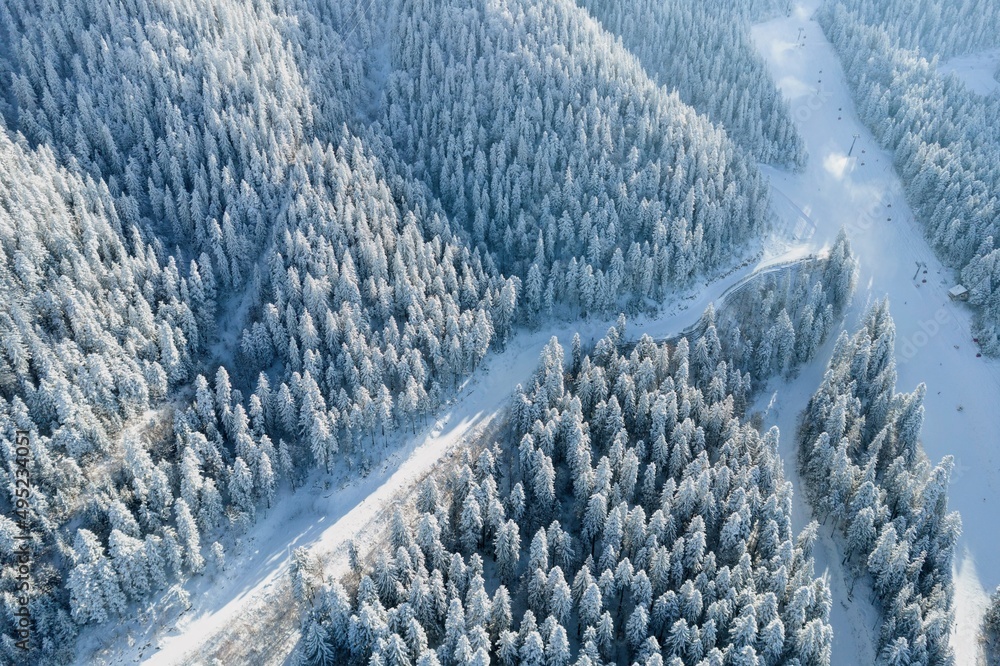 Aerial view of steep snowy ski slopes in winter mountain resort