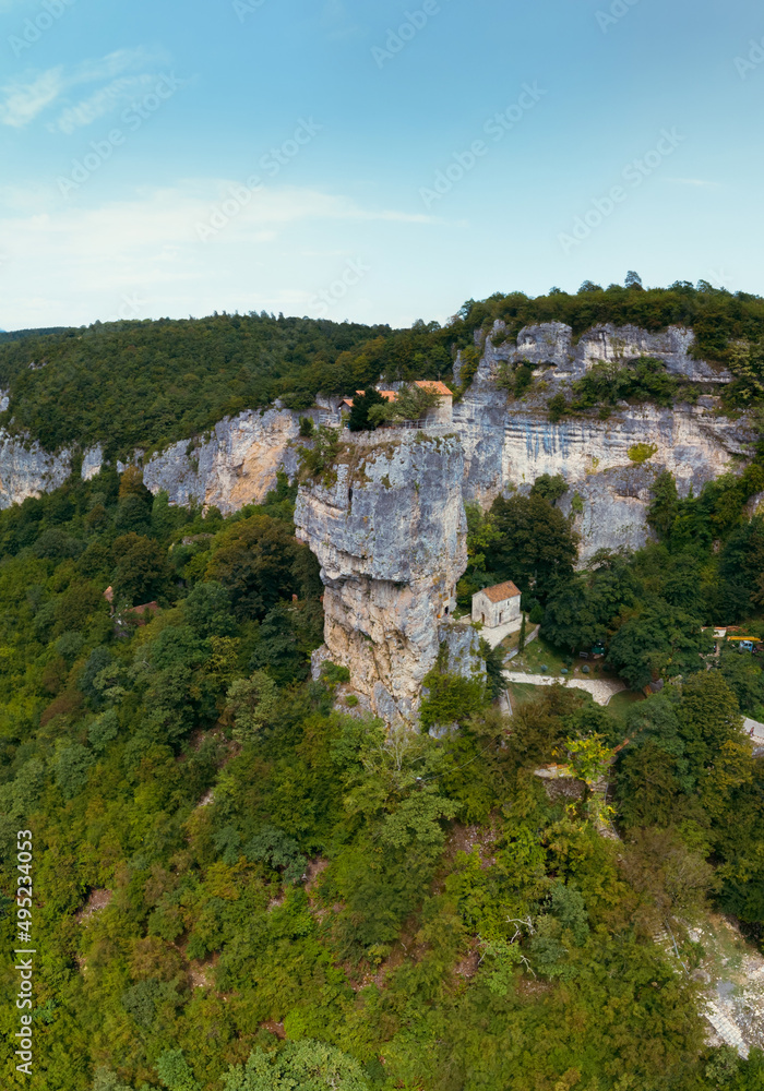 Aerial. Mountains Georgian landmarks, nature. Green forest. View from monastery rocky cliff. Katskhi Georgia. Summer day. Travel and tourism. Vertical photo Aerial. Mountains Georgian landmarks, nature. Green forest. View from monastery rocky cliff. Katskhi Georgia. Summer day. Travel and tourism. Vertical photo
