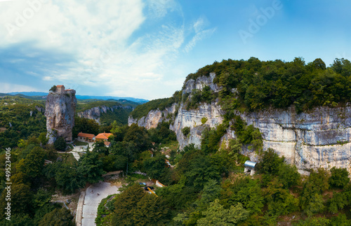 Wide aerial panorama. Katskhi pillar. Georgian landmarks. Man's monastery near the village of Katskhi. The orthodox church and the abbot cell on a rocky cliff. Imereti, Georgia.vTravel and tourism