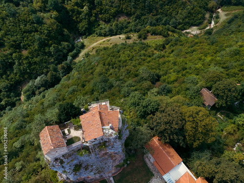 Aerial view. Katskhi pillar. Georgian landmarks. Man's monastery near the village of Katskhi. The orthodox church and the abbot cell on a rocky cliff. Imereti, Georgia. Summer day. Travel and tourism photo