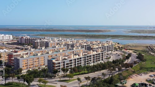 Aerial view of the urban area of portugal houses with modern infrastructure swimming pools overlooking the sea. Portugal's southern city of Olhao Ria Formosa