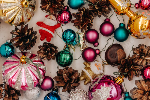 Christmas ornaments box with festive objects on a wooden background viewed from above. Top view