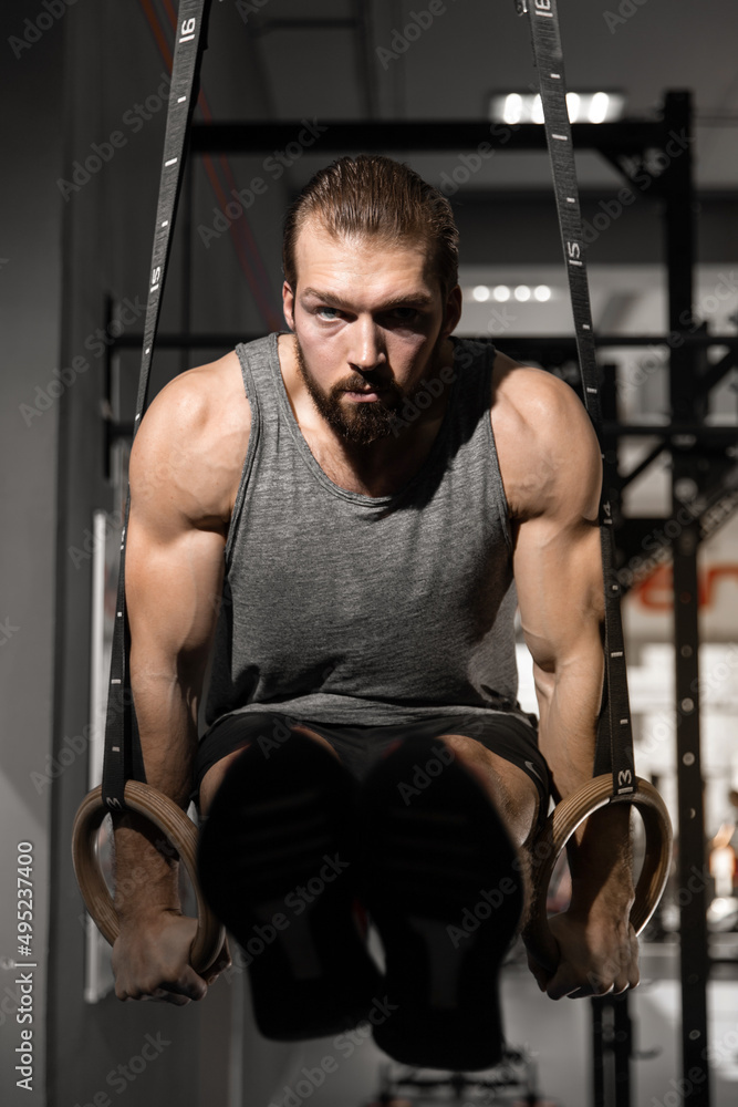 man doing exercises on uneven bars in the gym man doing exercises on uneven bars in the gym