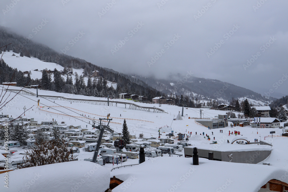 Sight to the foggy, snowy Landscape, the Gondula and Skiing Slopes of Churwalden, Switzerland in Wintertime