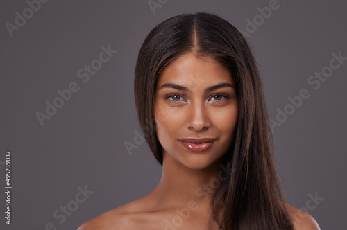 Looking gorgeous yet natural. Portrait of a beautiful young woman posing in the studio.