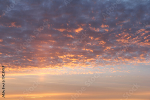 Sky and voluminous clouds at sunset. With light rays of the sun. Close up. © DIMA
