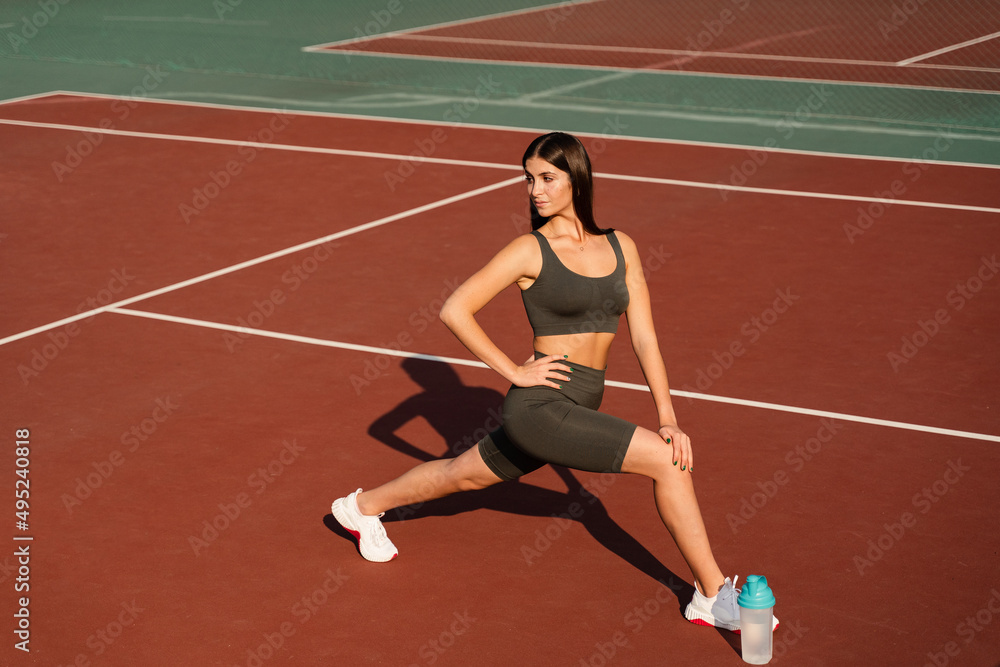 Workout exercise outdoor lunges. Attractive girl trains outside. Sports lifestyle.
