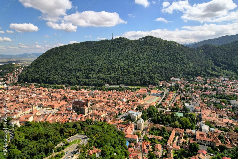 Aerial panorama view over the historical Old Town in the city of Brasov with Tampa mountain in the background. Transylvania, Romania