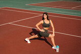 Workout exercise outdoor lunges. Attractive girl trains outside. Sports lifestyle.
