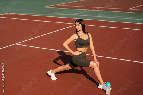 Workout exercise outdoor lunges. Attractive girl trains outside. Sports lifestyle. © Rabizo Anatolii