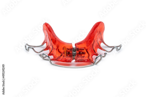REMOVABLE WIRE RETAINER ON WHITE BACKGROUND. ORTHODONTICS TREATMENTS. MOUTH HEALTH CARE CONCEPT. photo