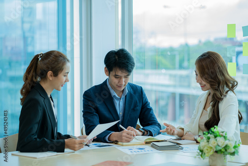 Businessman discussing initial projects A group of young Asian businessmen share ideas and propose new marketing and business ideas at the meeting.