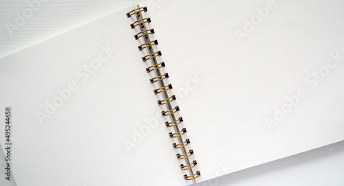 Open white spiral notebook, top view. Template, place for writing, for drawings, sketches.