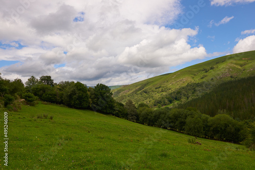 A mountain with lush vegetation under a cloudy sky