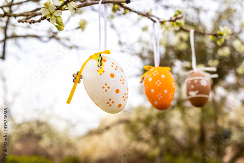 Happy Easter! Easter decorated eggs. Garden tree set up with multicolored Easter eggs.