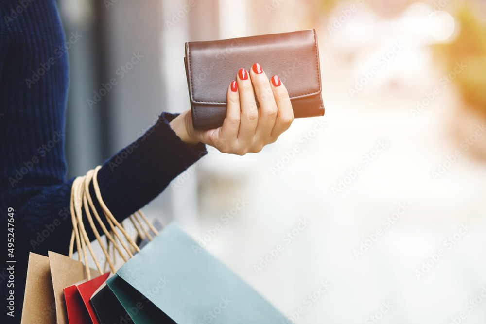 woman person holding a wallet in the hand. Cost control expenses shopping in concept. Leave space to write descriptive text. - obrazy, fototapety, plakaty 