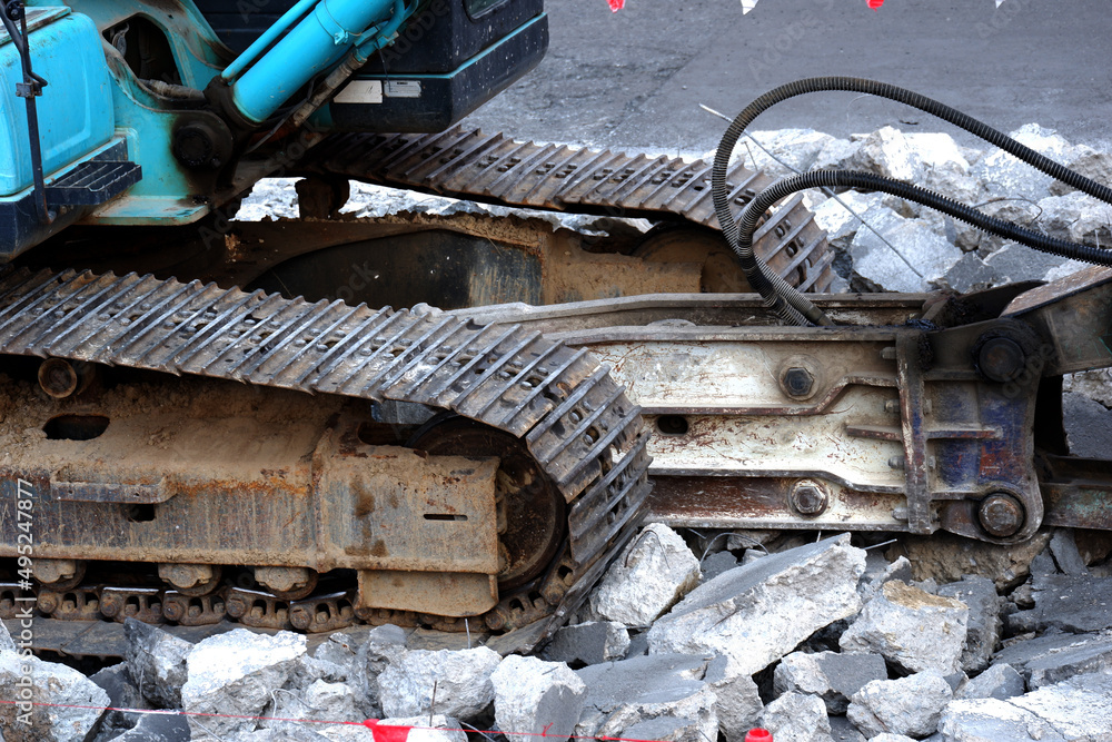 Rock excavator working to demolish concrete. Rock excavator working to demolish concrete.