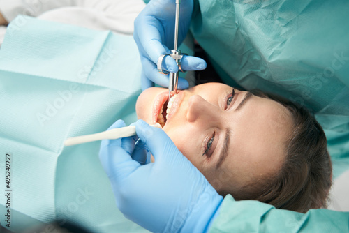 Woman receiving dental treatment in dentist office