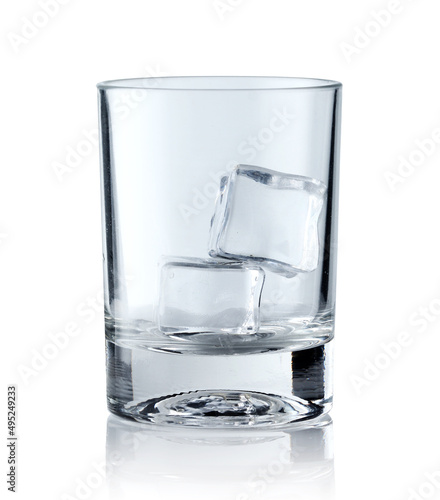 Ice cubes in empty glass on white background. Glass of water or whiskey and wine. Empty glass for alcoholic beverages
