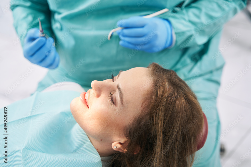 Woman lying in dental chair in dentist office Woman lying in dental chair in dentist office
