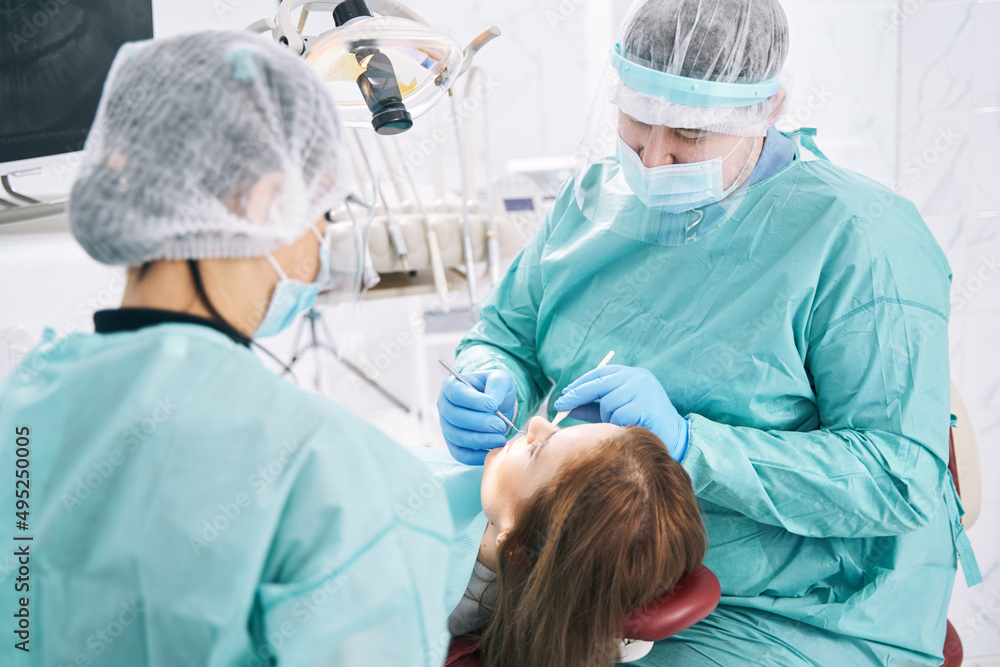 Woman receiving teeth treatment in stomatology clinic Woman receiving teeth treatment in stomatology clinic