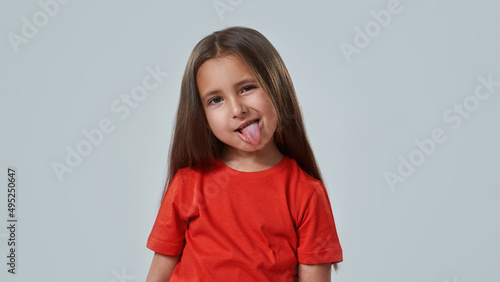 Partial of fun little girl sticking out tongue