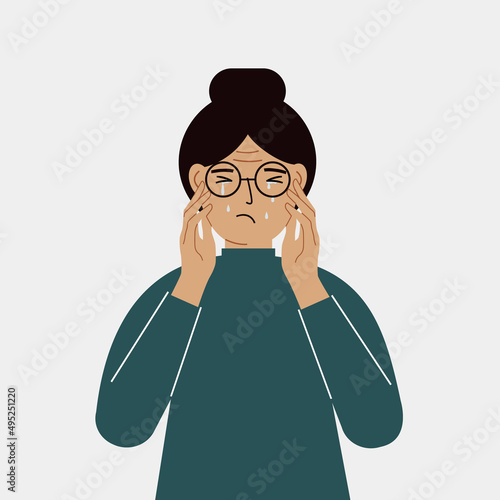 Upset woman cries and holds his head with his hands. The concept of resentment, pain and depression.