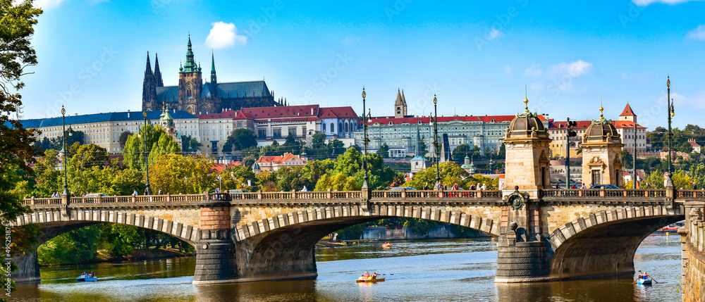 Legion bridge over the Vltava river with Prague Castle in the background, view on a sunny day.