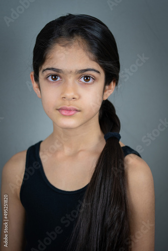 A school age Indian ethnicity girl - portrait shots with different facial expressions. 
