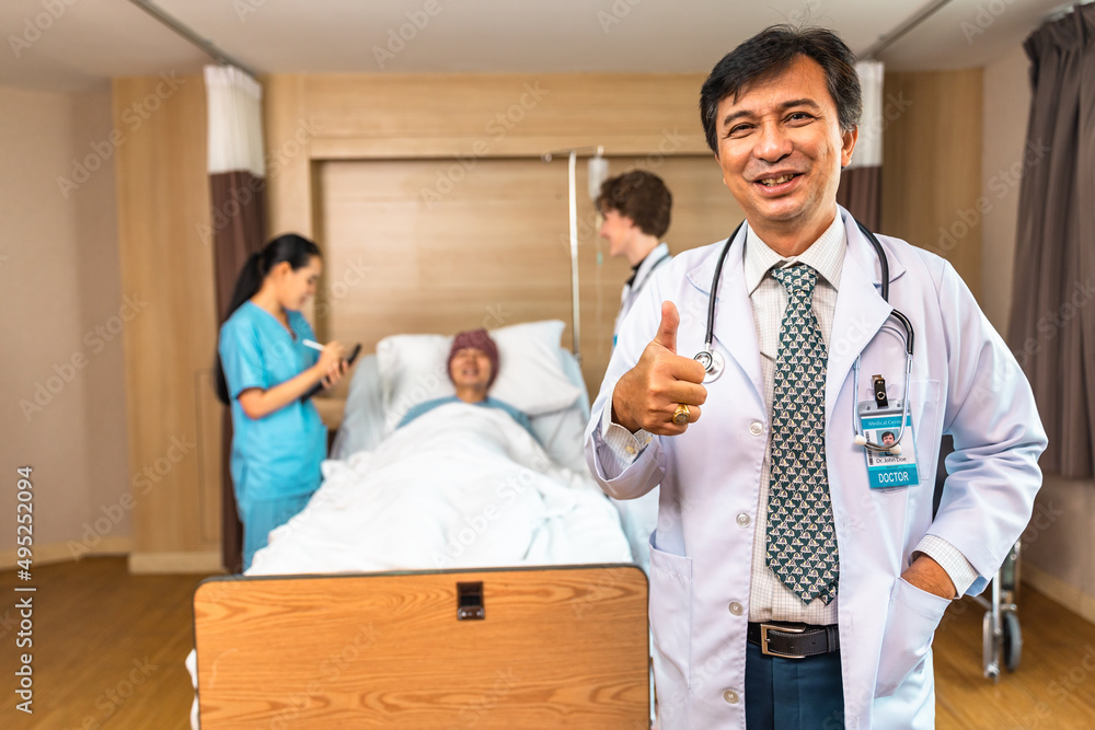 Young Asian elder man in medical robe smiling and looking at camera during work against at clinic.. healthcare medical checkup concept. Young Asian elder man in medical robe smiling and looking at camera during work against at clinic.. healthcare medical checkup concept.