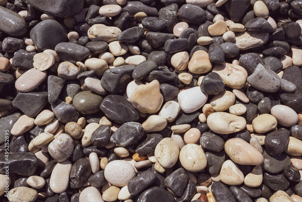 Texture of wet gray and white beach stones and pebbles Texture of wet gray and white beach stones and pebbles