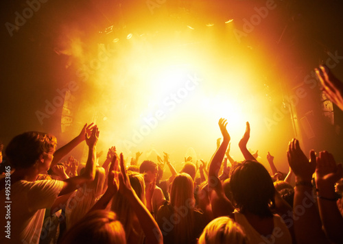 Rear-view of a crowd cheering at a concert- This concept was created for the sole purpose of this photo shoot, featuring 300 models and 3 live bands. All people in this shoot are model released