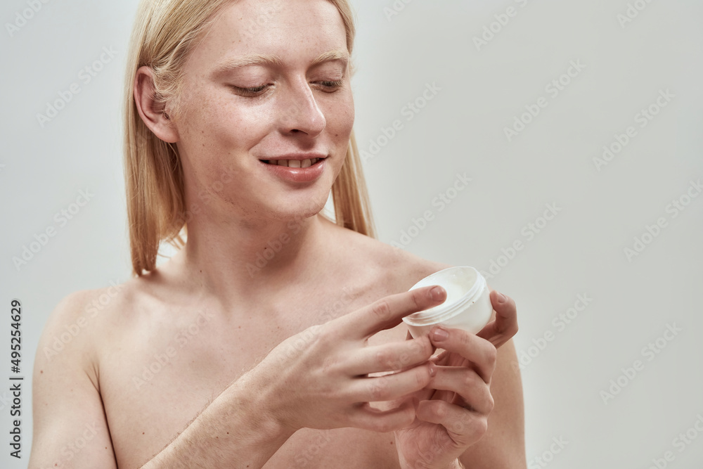 Partial of guy take cosmetic cream from container Partial of guy take cosmetic cream from container