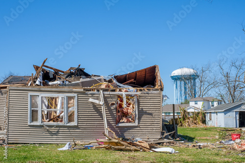 Front of Severely Damaged House from March 22, 2022 Tornado and Arabi Water Tower in Arabi, LA, USA photo