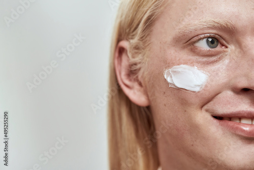 Obscure face of guy with cosmetic cream on face