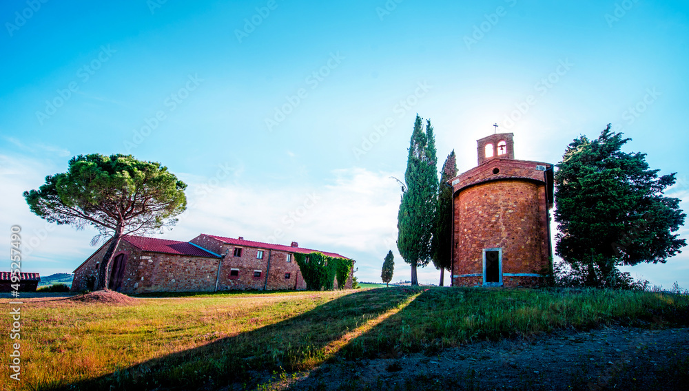 Magic landscape with chapel of Madonna di Vitaleta on a sunny day in San Quirico d'Orcia (Val d'Orcia) in Tuscany, Italy. Excellent tourist places.