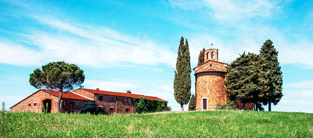 charming landscape with chapel of Madonna di Vitaleta near rape fiald on a sunny day in San Quirico d'Orcia (Val d'Orcia) in Tuscany, Italy. Excellent tourist places.