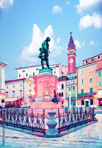 Obraz na płótnie Beautiful amazing city scenery with the monument the famous Italian violinist and composer Giuseppe Tartini and old clock tower in the central square in Piran, the tourist center of Slovenia. w salonie