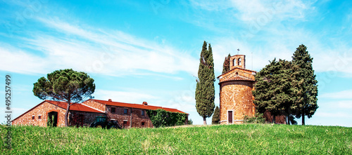 charming landscape with chapel of Madonna di Vitaleta near rape fiald on a sunny day in San Quirico d'Orcia (Val d'Orcia) in Tuscany, Italy. Excellent tourist places. photo